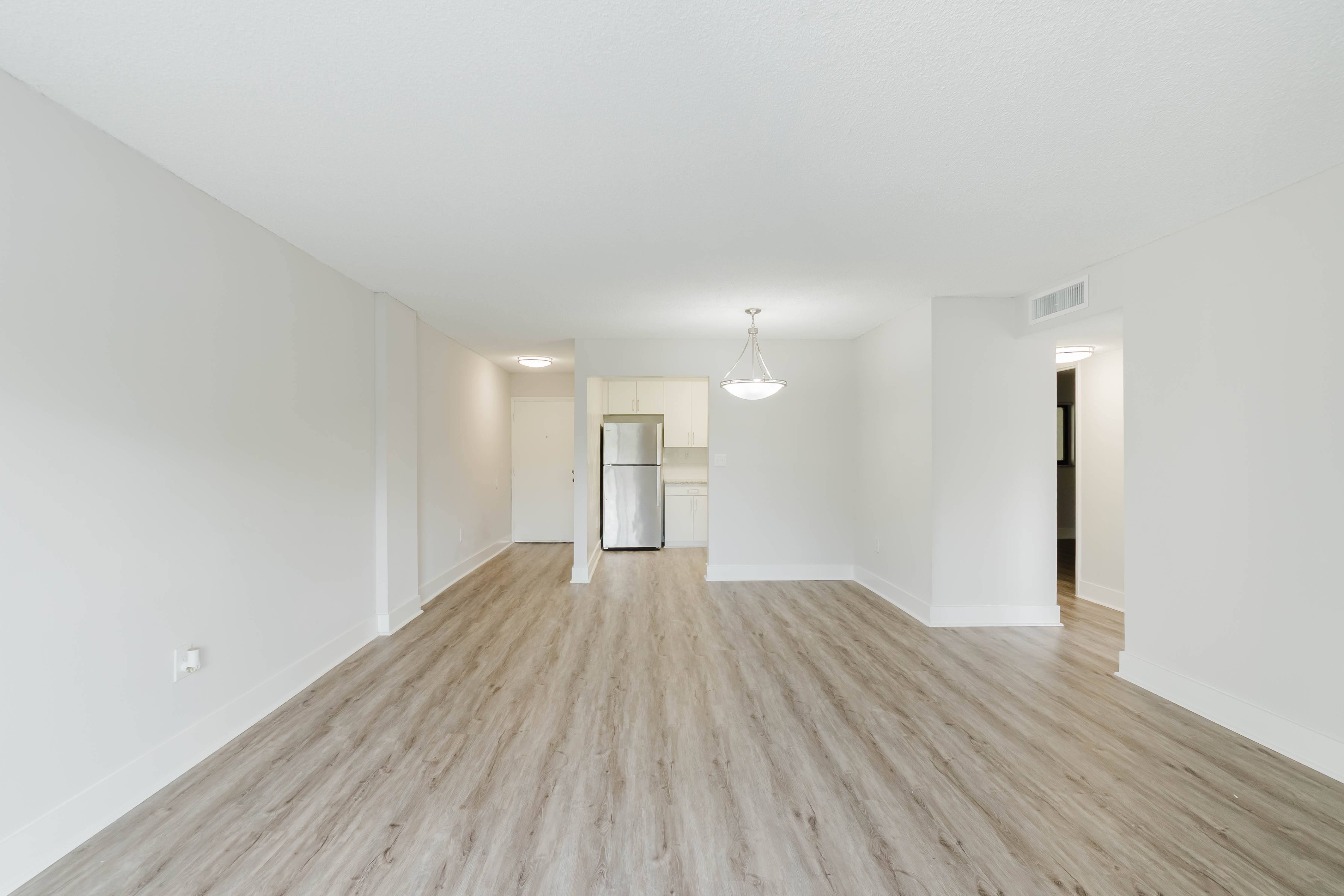 A room with wooden floors and white walls.